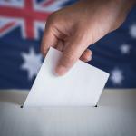 Hand putting ballot in box